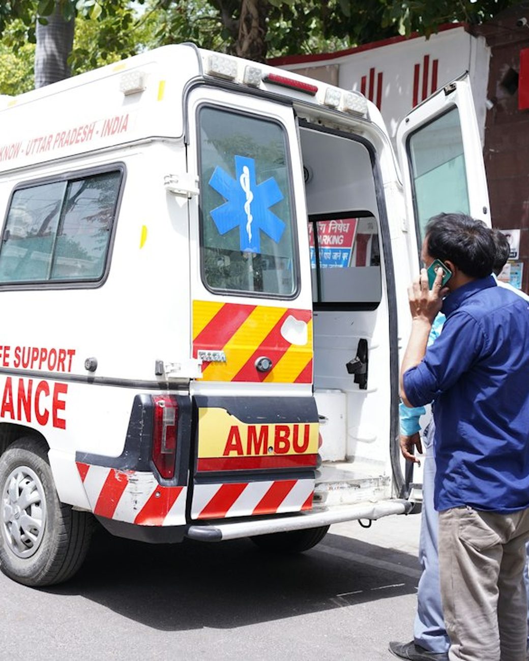 An ambulance with its rear doors open at a roadside